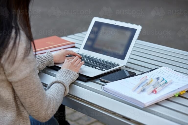 young-female-student-studying-on-her-laptop-outdoors-austockphoto-000112028